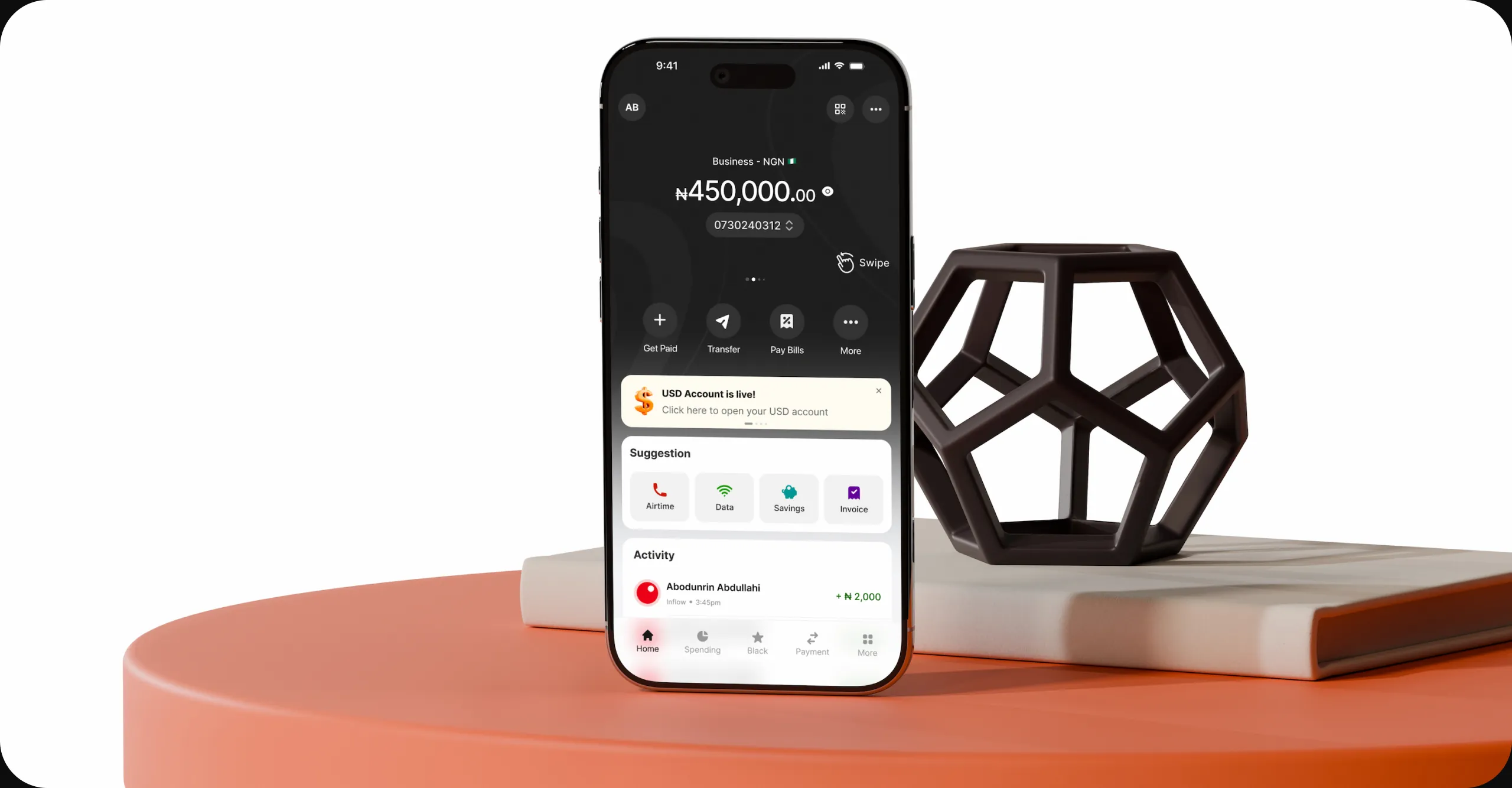 Nomba business account dashboard on mobile over a styled product scene