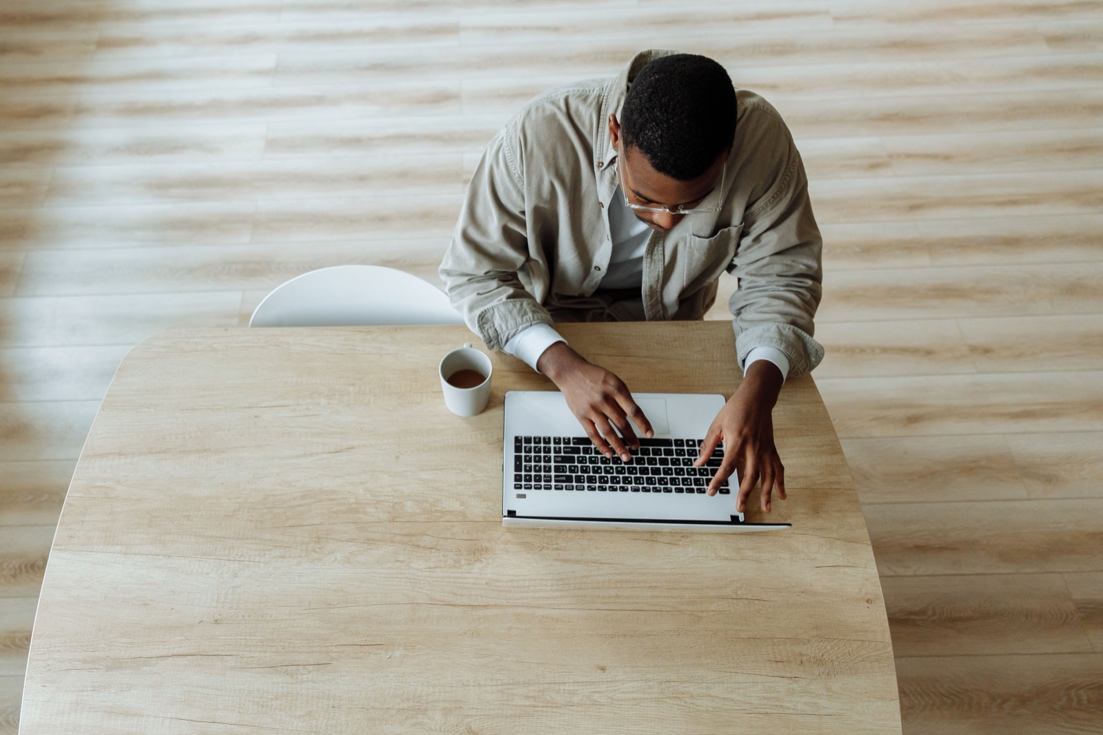 A professional working on a laptop at a clean desk