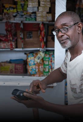 man in a shop holding a POS machine