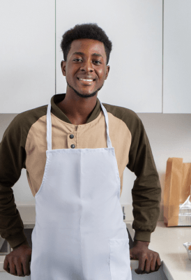 man wearing an apron and smiling